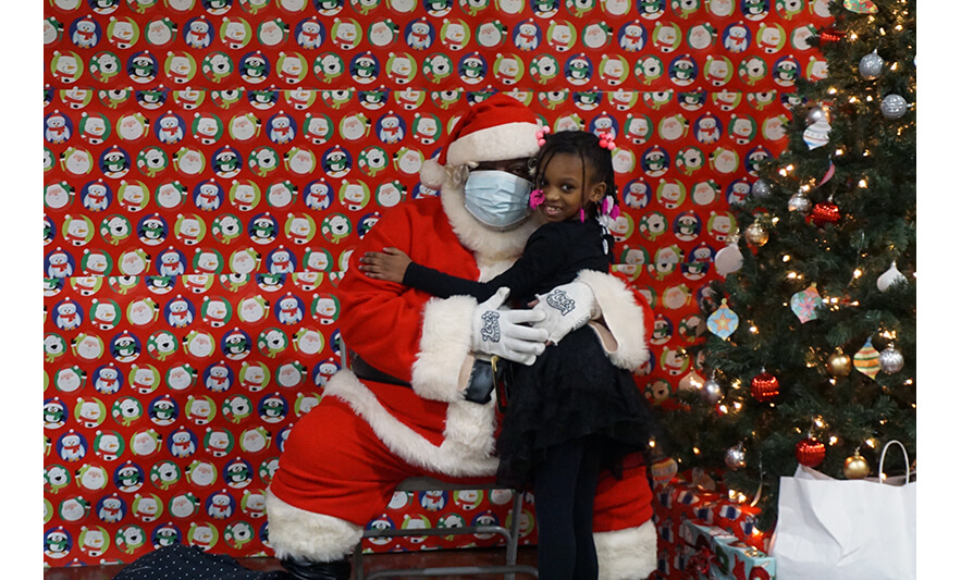 Breakfast with Santa 12-17-2022 Girl hugging Santa for web