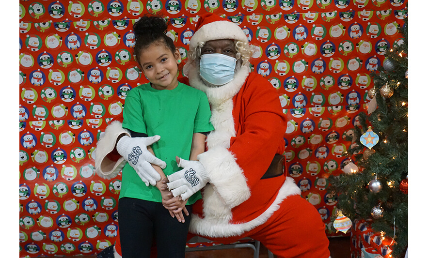 Breakfast with Santa 12-17-2022 Girl in green with Santa for web