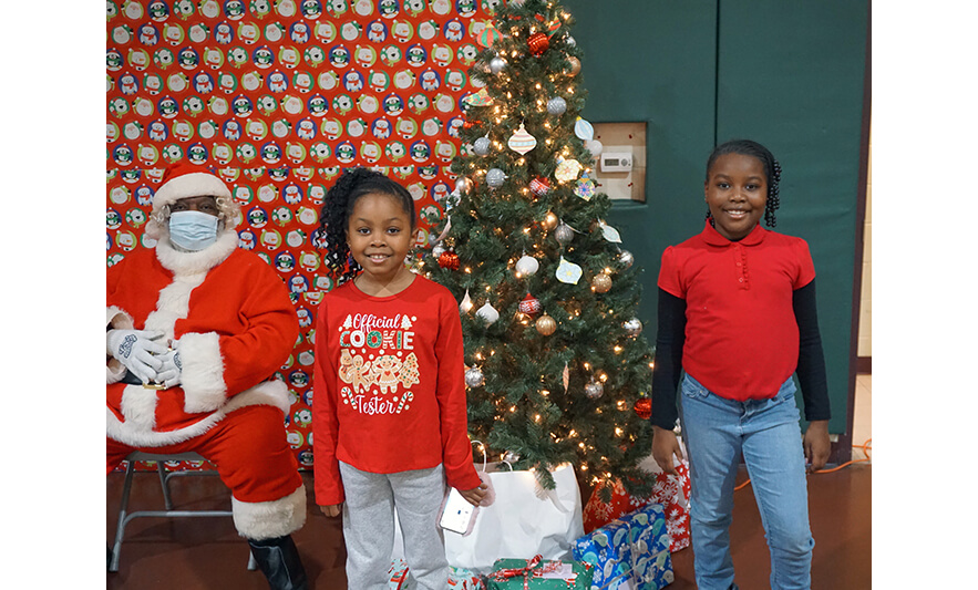 Breakfast with Santa 12-17-2022 Pair standing by tree and Santa for web