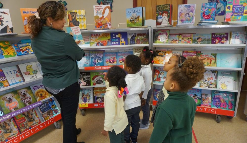 CHELC Book Fair Teacher Showing Book