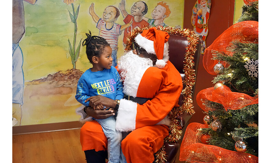 CHELC Santa Visit 12-16-2022 Boy in blue looking at Santa for web