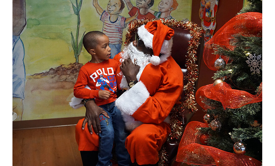 CHELC Santa Visit 12-16-2022 Boy in Polo shirt talking to Santa for web
