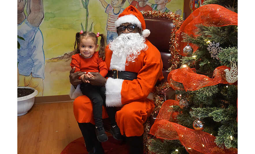 CHELC Santa Visit 12-16-2022 Girl in pigtails smiling for web