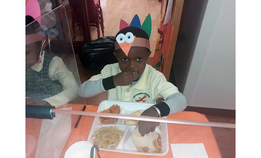 CHELC Thanksgiving 2021 Boy eating for web