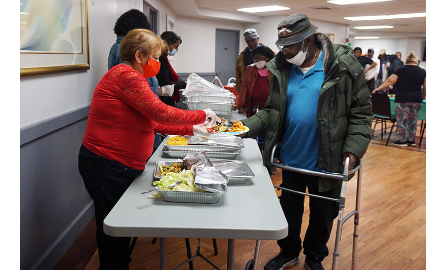 Commons Senior Christmas Luncheon 12-6-2022 Man getting food for web