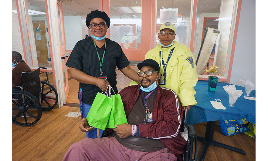 Extended Care Adopt-a-Resident Day 5-15-2024 Giving green bags to resident for web