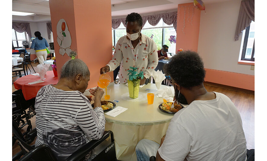 Extended Care Adopt-a-Resident Day 5-15-2024 Julienne Van-Nooten pouring juice for web