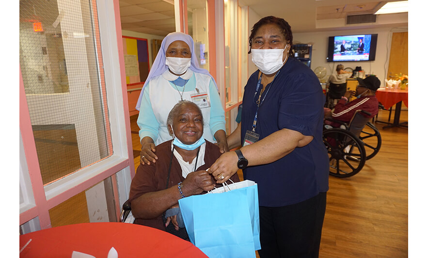 Extended Care Adopt-a-Resident Day 5-15-2024 Sister Elizabeth Lima and Christiana Agbozo with resident for web