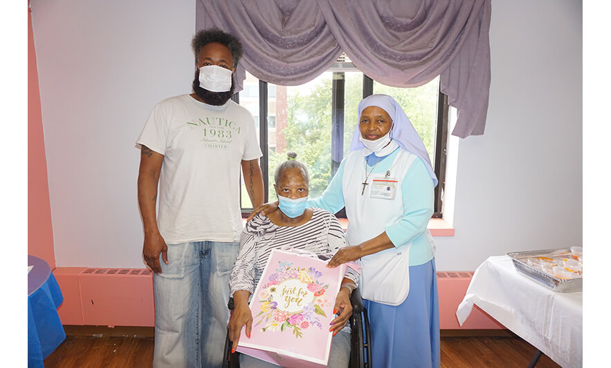 Extended Care Adopt-a-Resident Day 5-15-2024 Sister Elizabeth Lima with woman and son for web