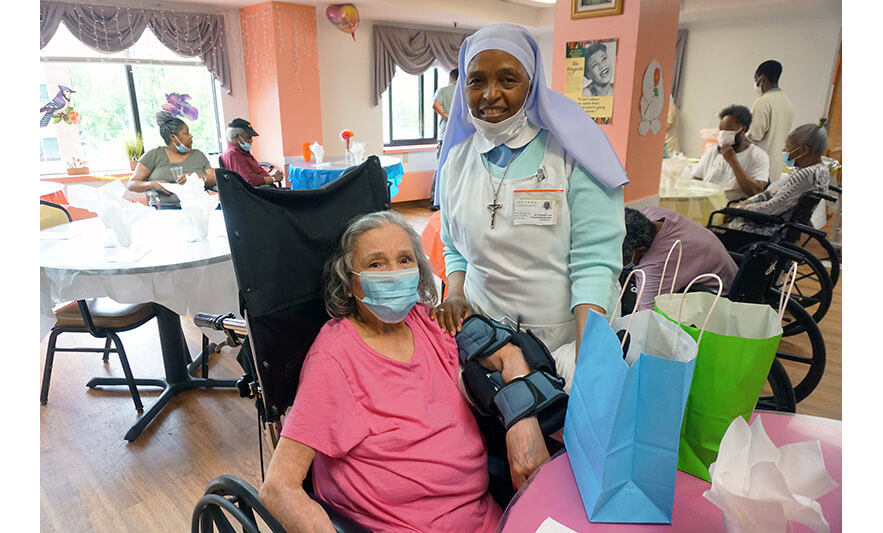 Extended Care Adopt-a-Resident Day 5-15-2024 Sister Elizabeth Lima with woman in pink for web