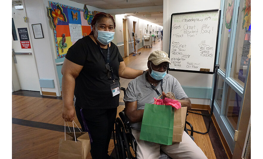 Extended Care Adopt-a-Resident Day 5-15-2025 Christiana with man in hallway for web