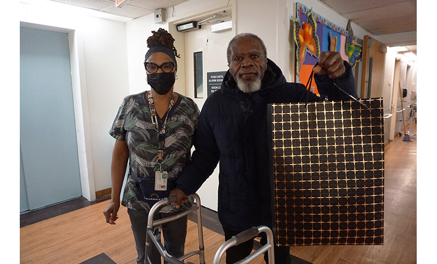 Extended Care Adopt-a-Resident Day 5-15-2025 Man holding up black bag for web
