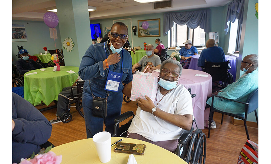 Extended Care Adopt-a-Resident Day 5-15-2025 Smiling pair with pink bag for web