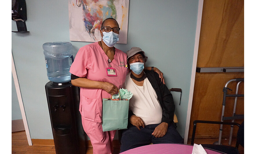 Extended Care Adopt-a-Resident Day 5-15-2025 Staffer in pink with man in hat for web