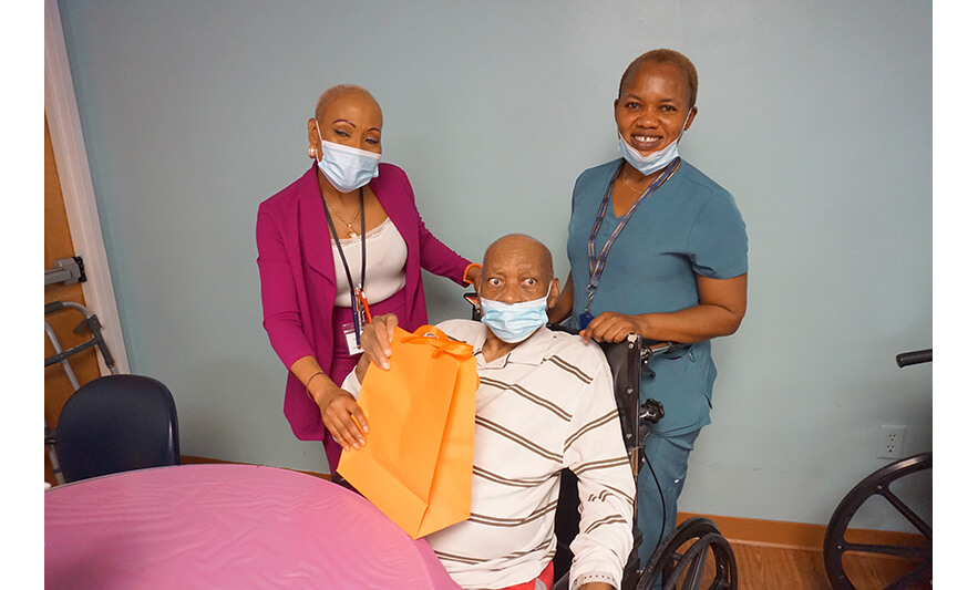 Extended Care Adopt-a-Resident Day 5-15-2025 Veronica Onwunaka and staffer with man for web