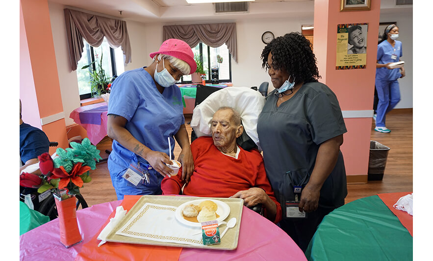 Extended Care Adopt-A-Resident Day 5-17-2023 Employees with man in red for web