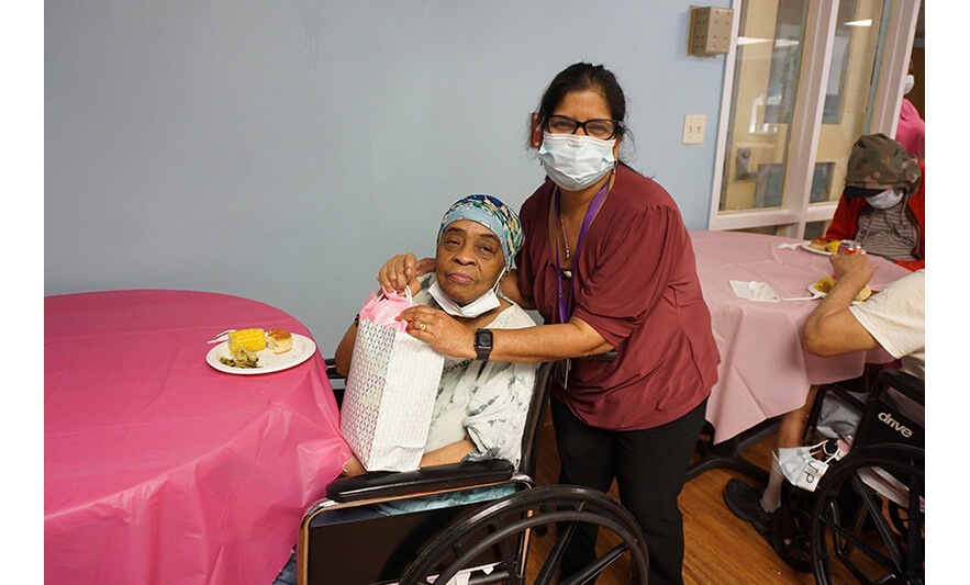 Extended Care Adopt-A-Resident Day 5-17-2023 Martinha Gracias giving gift for web