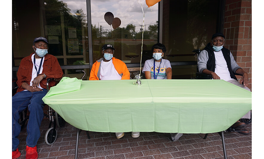 Extended Care Cookout 5-19-2023 Veronica Onwunaka with three men for web