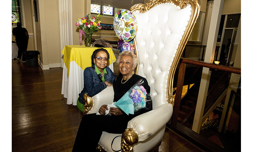 Madge Wilson 89th Birthday 4-12-2022 Madge Wilson with flowers and kneeling woman for web