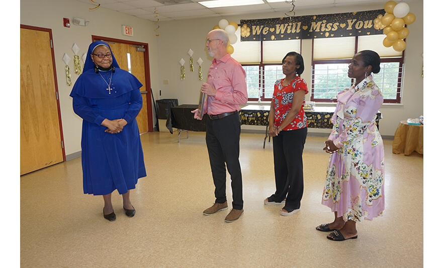 Sister Maurice Surprise Farewell 6-30-2023 Ben Galvez Frances Tabout Simone Gagneron presenting plaque for web
