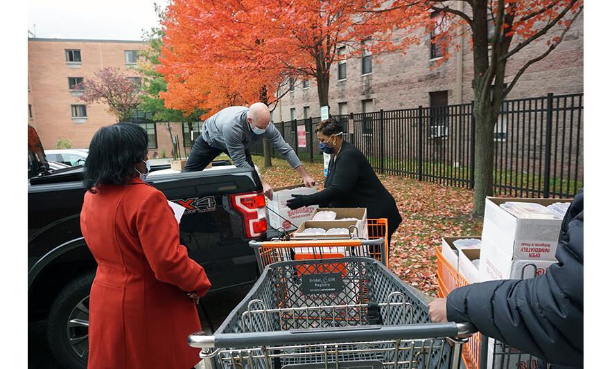 Withum Harmony House Thanksgiving 11-22-2021 Mike Pintabone handing box to Jennifer Wicker-Buchanan for web