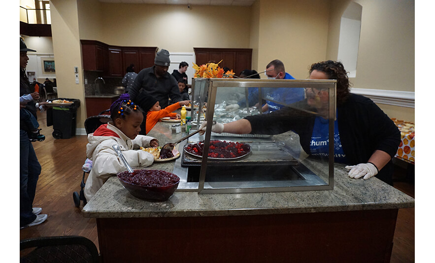 Withum Harmony House Thanksgiving Dinner 11-21-2022 Girl getting cranberry sauce for web