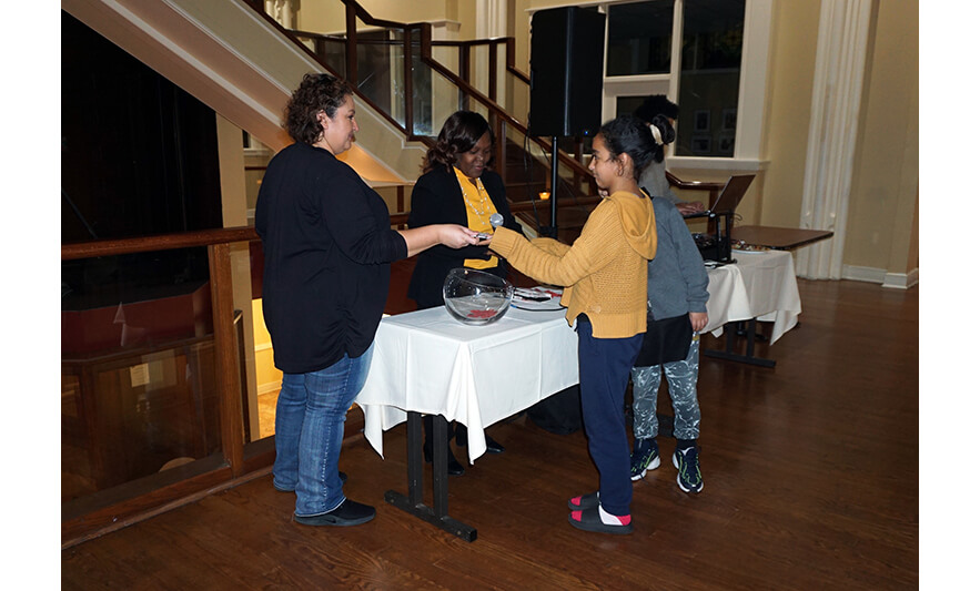 Withum Harmony House Thanksgiving Dinner 11-21-2022 Girl in yellow getting gift card for web