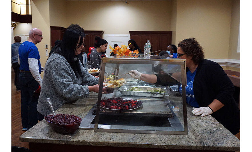 Withum Harmony House Thanksgiving Dinner 11-21-2022 Woman getting vegetables for web